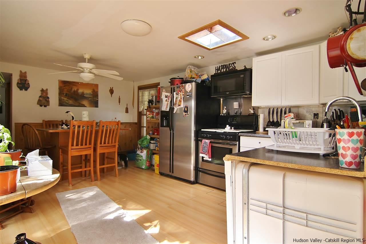 95 Pine Avenue Catskill, NY 12463 - Photo 3 of 10 a kitchen with stainless steel appliances kitchen island granite countertop a refrigerator and a sink
