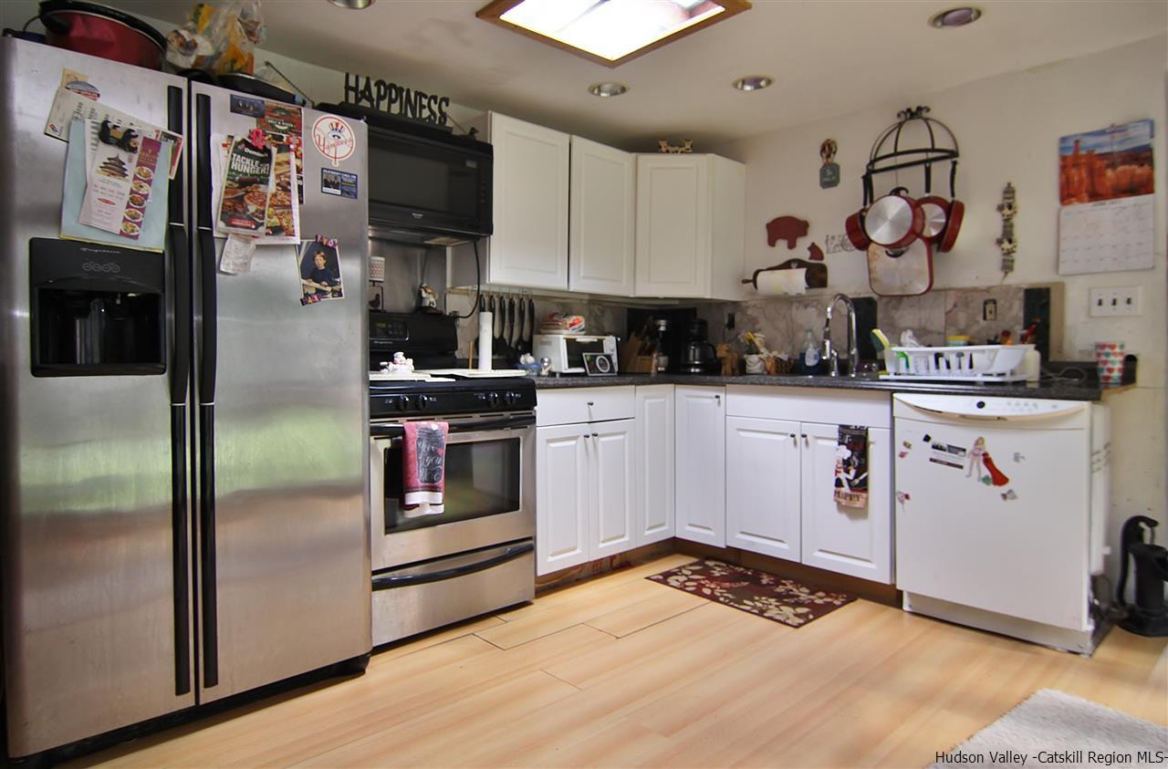 95 Pine Avenue Catskill, NY 12463 - Photo 4 of 10 a kitchen with stainless steel appliances granite countertop a refrigerator and a stove top oven