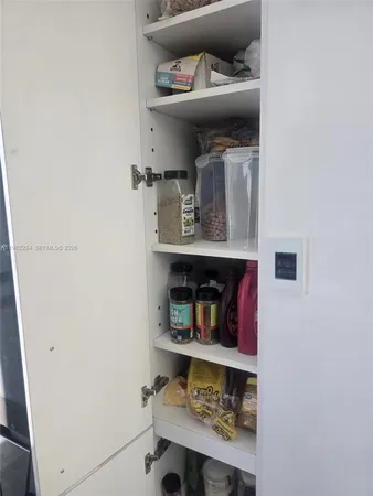 a kitchen with stainless steel appliances kitchen island granite countertop furniture and a fireplace