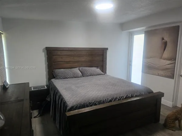 a bedroom with a bed and a lamp on desk