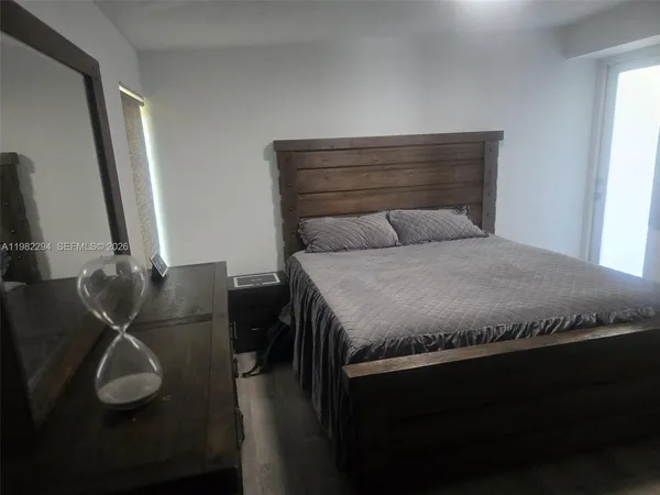 a bedroom with a bed and cabinet