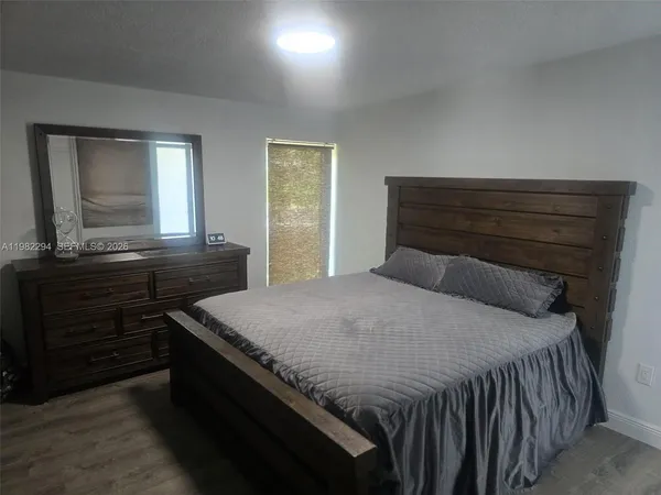 a bedroom with a bed and flat screen tv