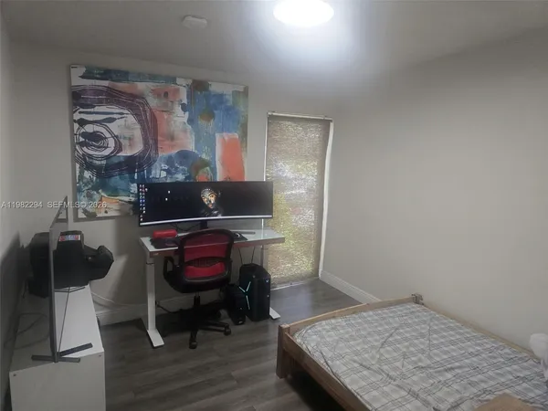 a bedroom with a bed and flat screen tv