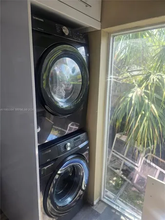 a room with wooden floor pool table and chairs