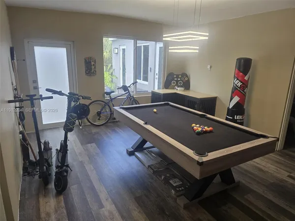 a front view of a house with swimming pool and furniture