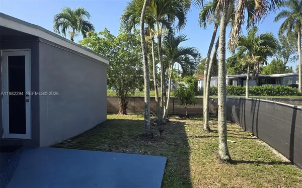 a backyard of a house with a fountain
