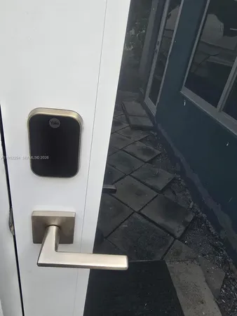 a view of a patio with table and chairs potted plants