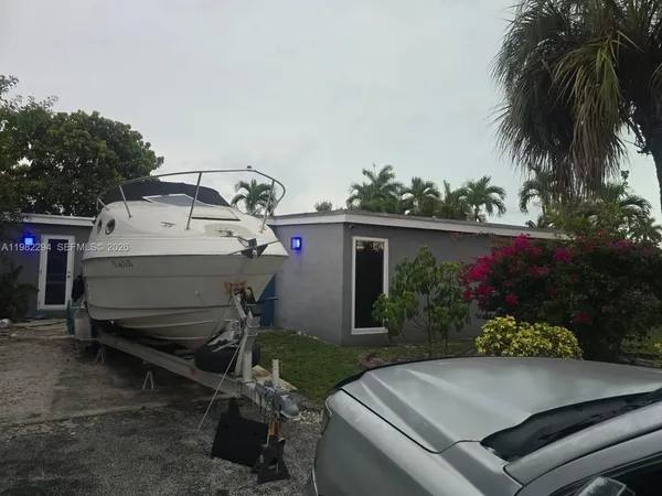 a yellow plant in front of a door