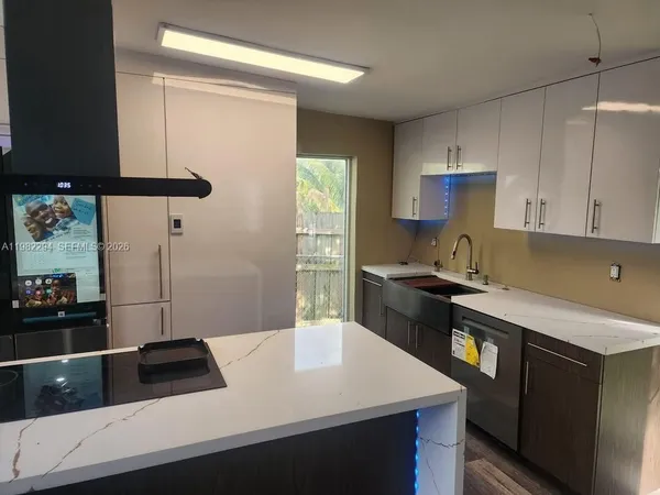 a living room with furniture pool and a flat screen tv
