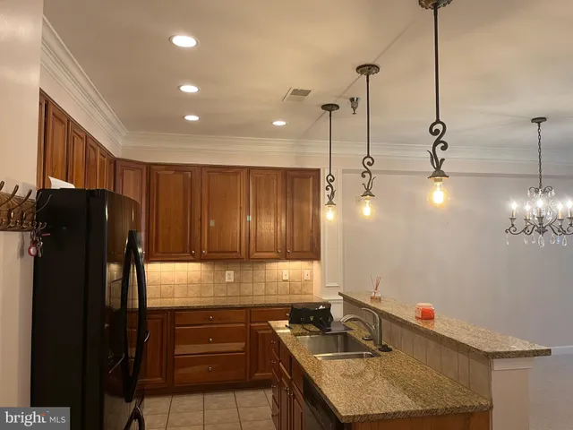 a view of a hallway with chandelier and a chandelier
