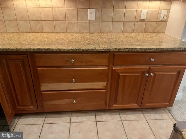 a kitchen with granite countertop a sink a stove and a microwave