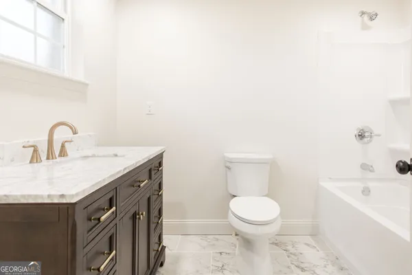 a bathroom with a sink a toilet and a bathtub