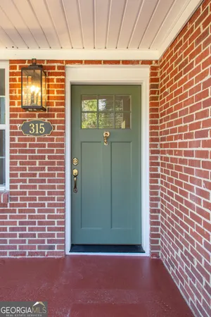 a view of a door and brick wall