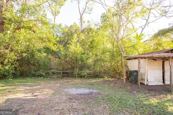 a view of a backyard with large trees