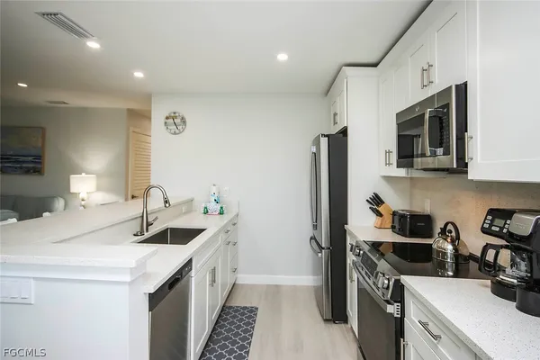 a kitchen with a sink stove and microwave