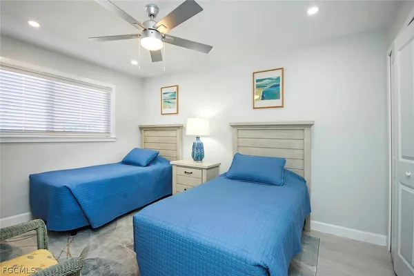 a bedroom with two beds and a window