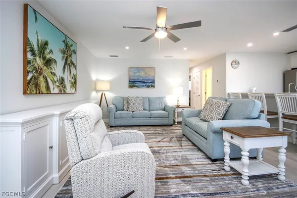 a living room with furniture and a ceiling fan