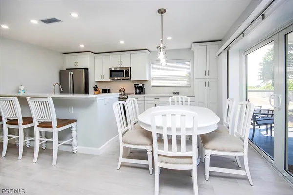 a dining room with furniture a window and kitchen view