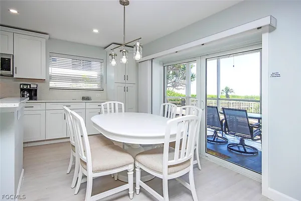 a dining room with furniture a chandelier and window