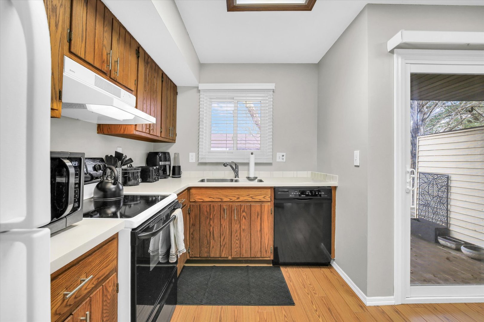 1802 Beck Drive, Unit 7 Urbana, IL 61802 - Photo 12 of 26 a kitchen with stainless steel appliances granite countertop a sink and cabinets
