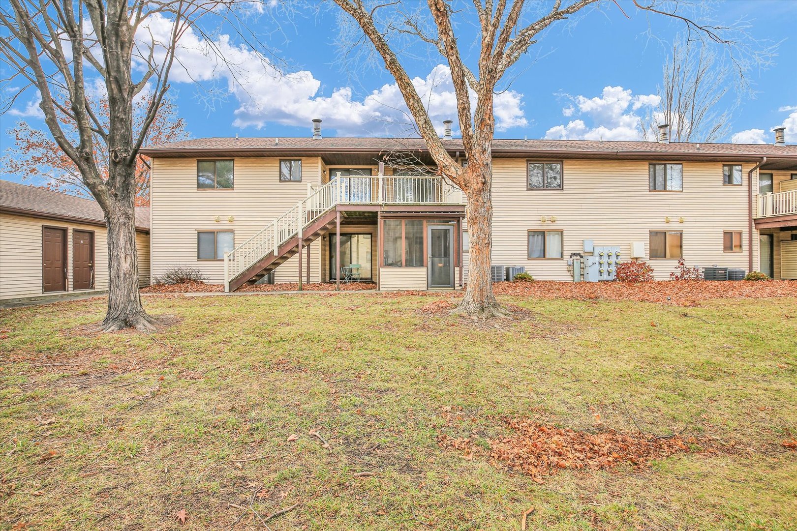 1802 Beck Drive, Unit 7 Urbana, IL 61802 - Photo 24 of 26 a front view of a house with a garden and trees