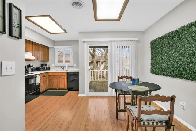 a kitchen with a table chairs a sink and cabinets