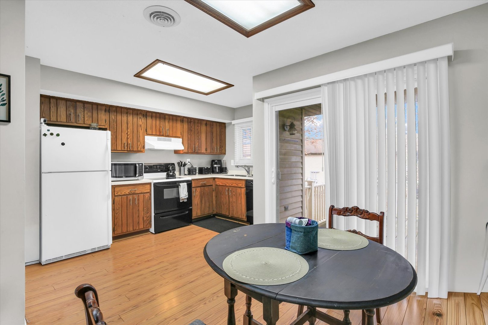 1802 Beck Drive, Unit 7 Urbana, IL 61802 - Photo 10 of 26 a kitchen with a refrigerator a stove a sink and a dining table