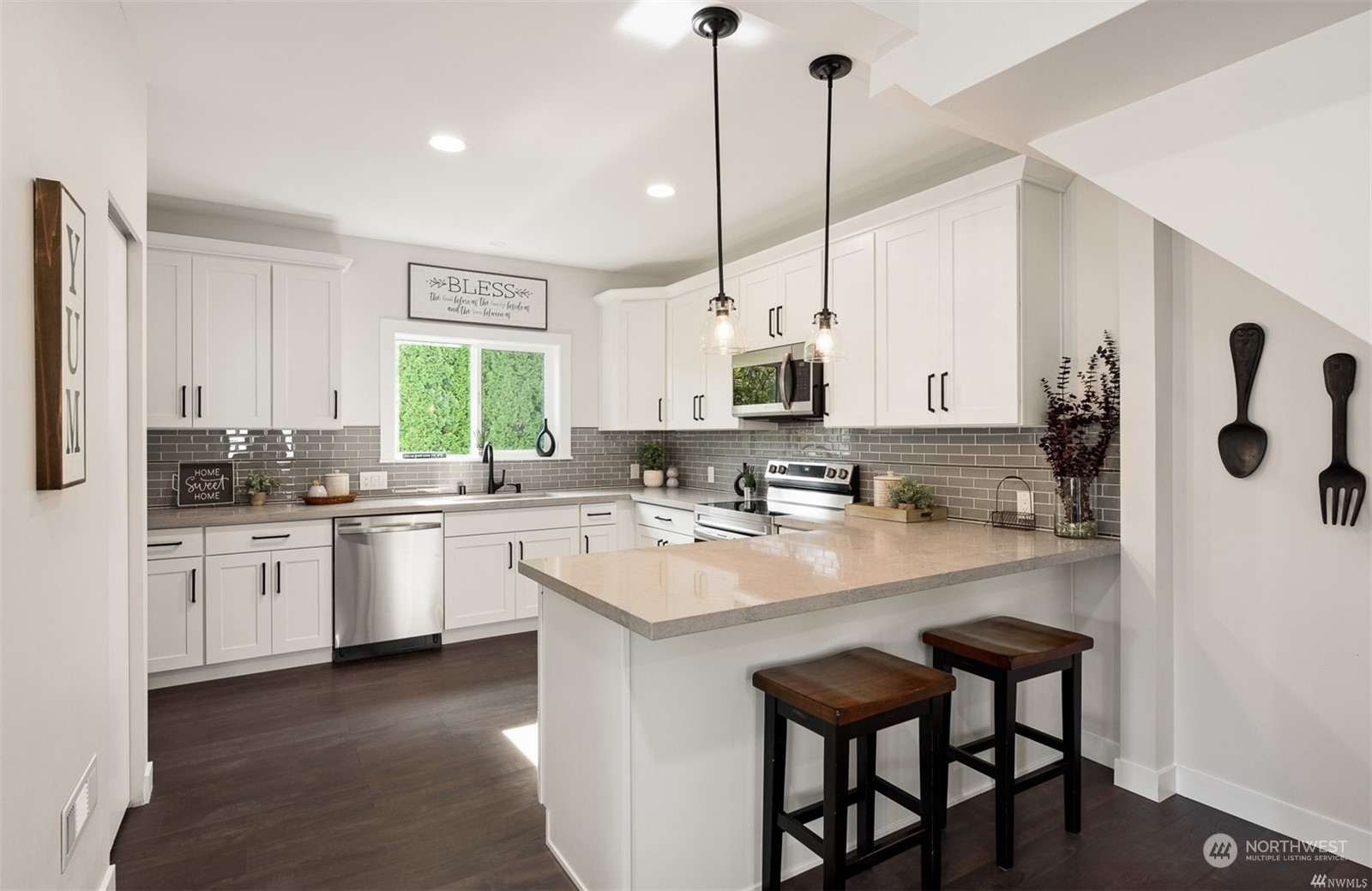 408 Nelson Street Sedro-Woolley, WA 98284 - Photo 5 of 25 a kitchen with stainless steel appliances granite countertop a sink a stove a refrigerator a center island with a dining table and chairs
