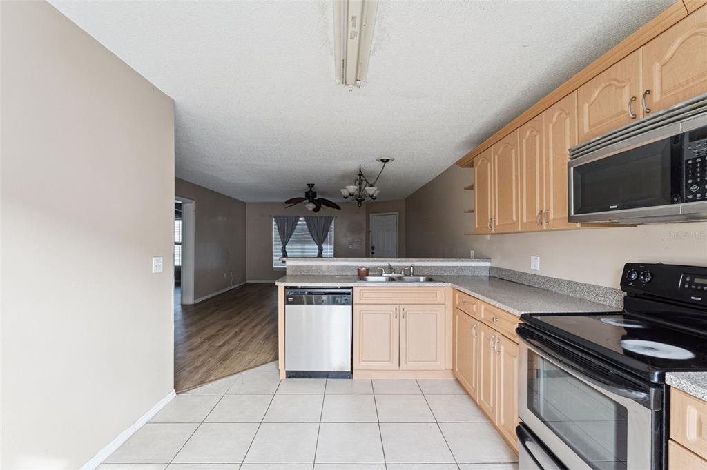 3651 North Goldenrod Road, Unit 110 Winter Park, FL 32792 - Photo 11 of 19 a kitchen with a sink and a stove top oven