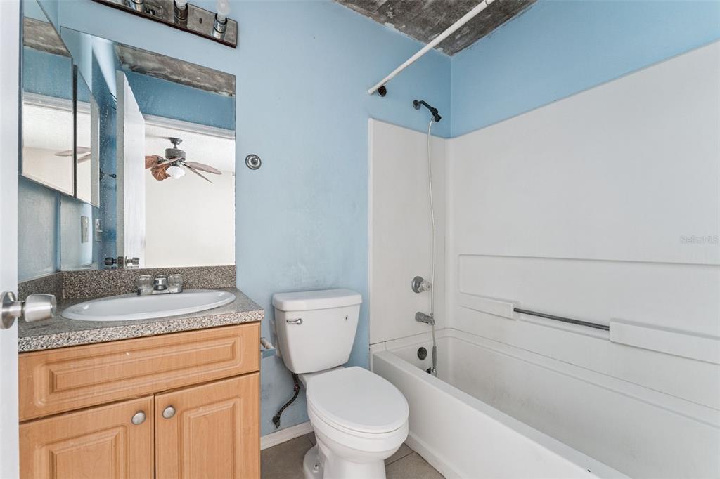 3651 North Goldenrod Road, Unit 110 Winter Park, FL 32792 - Photo 18 of 19 a bathroom with a granite countertop toilet sink and mirror