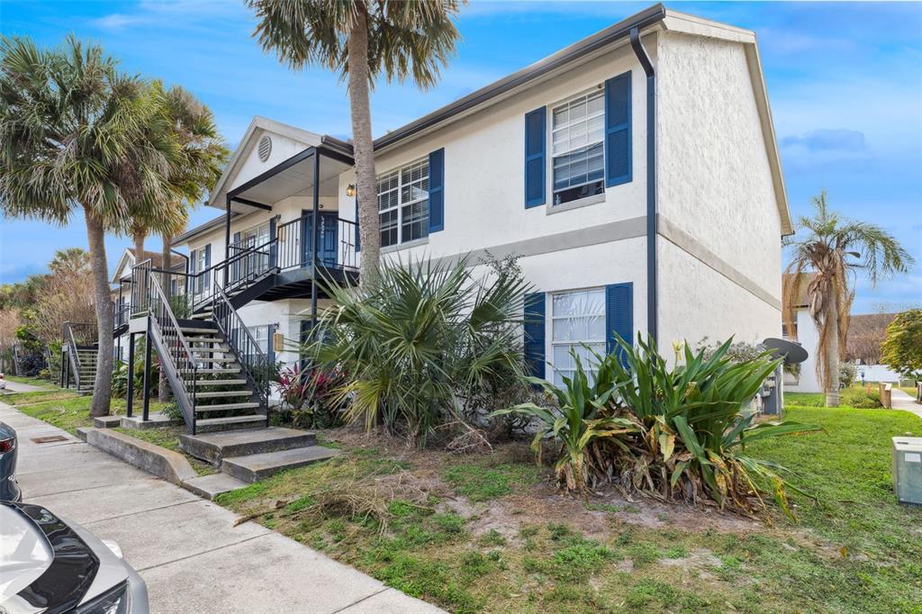 3651 North Goldenrod Road, Unit 110 Winter Park, FL 32792 - Photo 2 of 19 a front view of a house with a garden