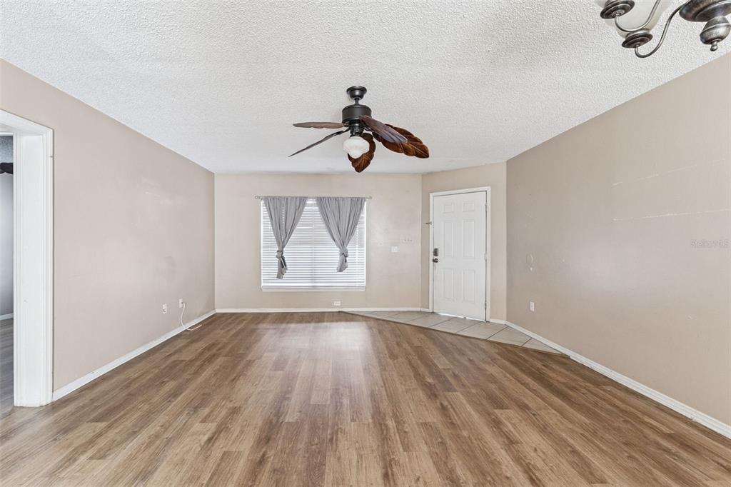 3651 North Goldenrod Road, Unit 110 Winter Park, FL 32792 - Photo 6 of 19 a view of empty room with wooden floor and fan