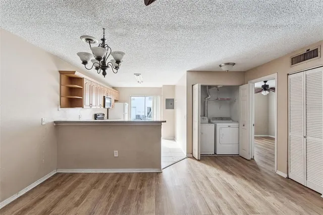 a view of a kitchen with a sink and refrigerator