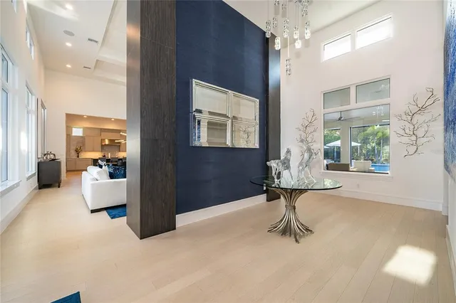 a large kitchen with kitchen island a potted plant a sink a counter space and cabinets