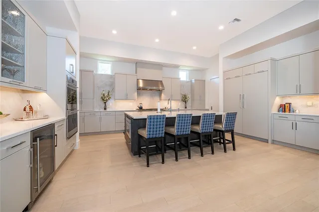 a spacious bathroom with a double vanity sink a mirror and a bathtub