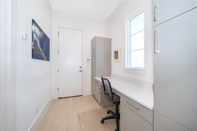 a bedroom with a bed a flat screen tv and view