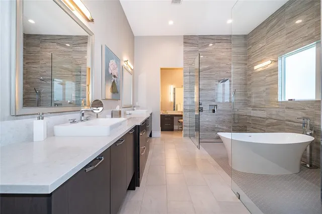 a living room with furniture a large window with kitchen view