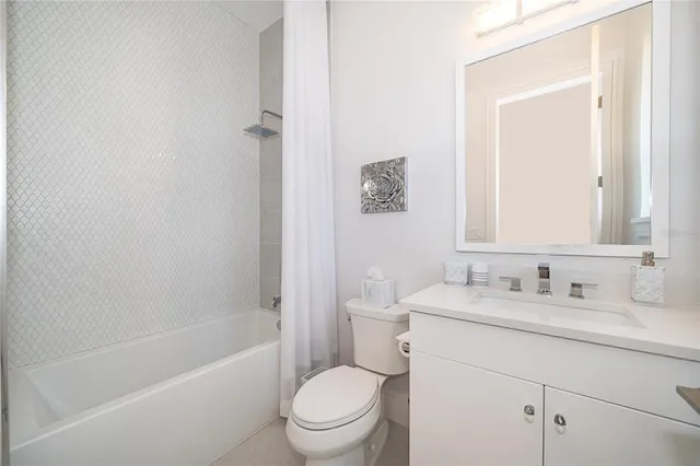 an aerial view of a house with garden space and street view