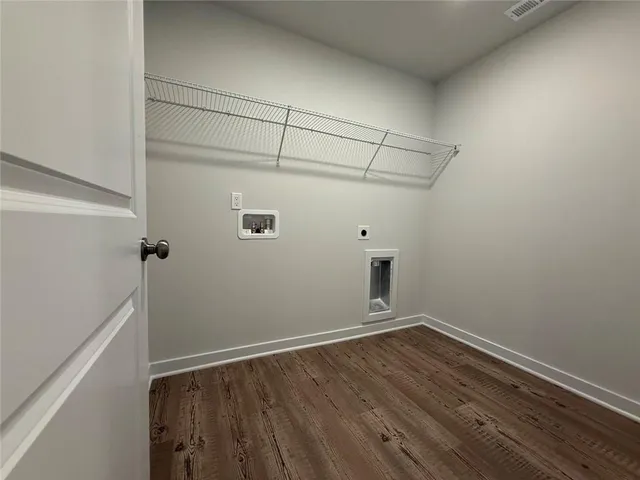 a view of a room with wooden floor