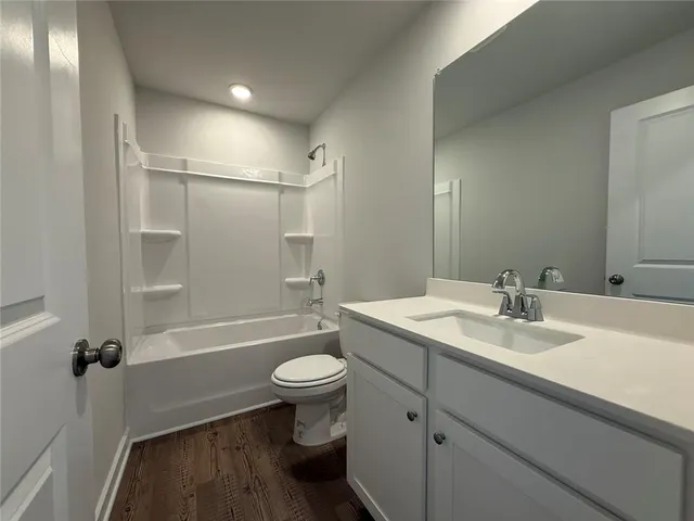 a bathroom with a sink toilet a mirror and shower