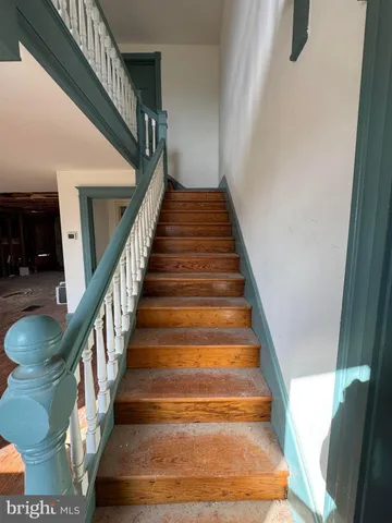 a view of a livingroom with wooden floor and a window