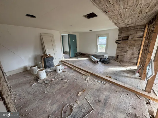 a view of a porch with chairs and a potted plant
