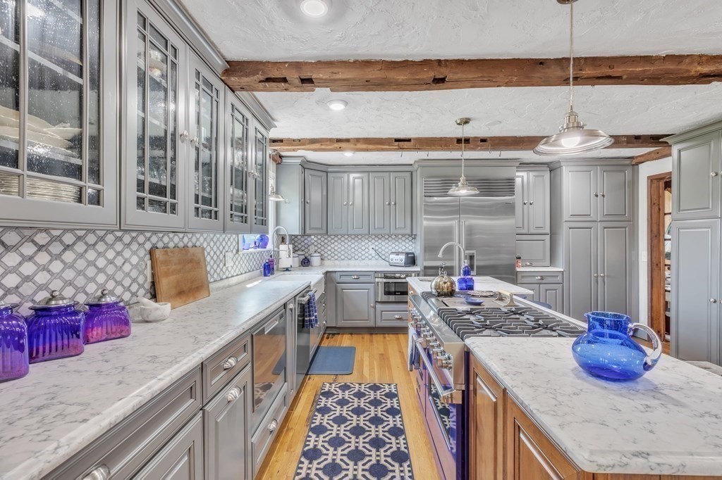 31 Washington Street Mendon, MA 01756 - Photo 13 of 40 a kitchen with stainless steel appliances granite countertop a sink stove and cabinets