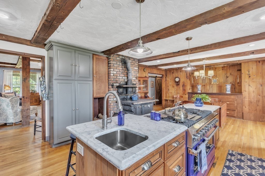 31 Washington Street Mendon, MA 01756 - Photo 14 of 40 a kitchen with a sink stove and wooden floor