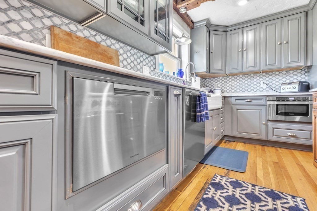 31 Washington Street Mendon, MA 01756 - Photo 17 of 40 a kitchen with stainless steel appliances granite countertop a stove a sink and a microwave