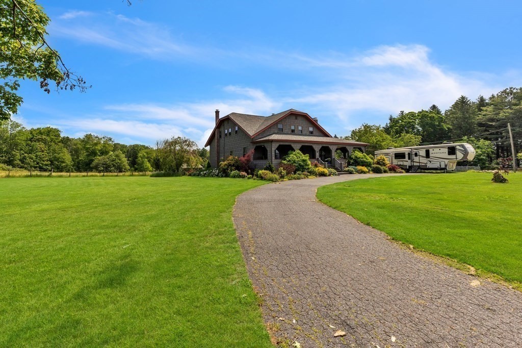31 Washington Street Mendon, MA 01756 - Photo 2 of 40 a front view of a house with a yard