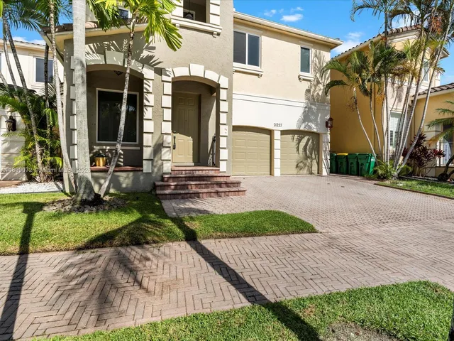 a front view of a house with garden