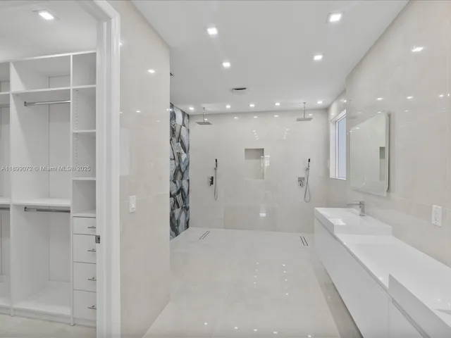 a bathroom with a glass shower door