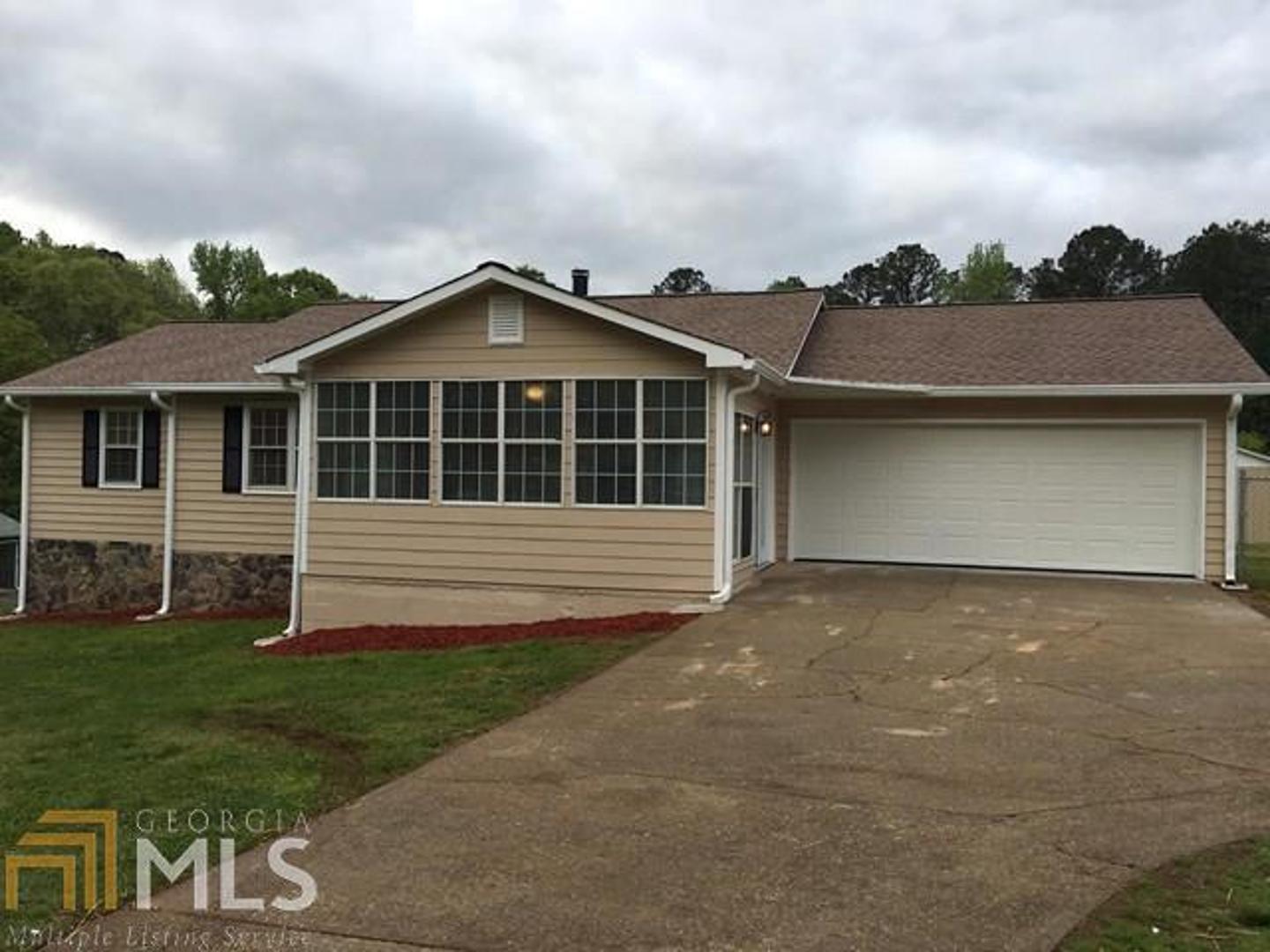 1009 Stagecoach Road Stockbridge, GA 30281 - Photo 1 of 1 a front view of a house with a garden
