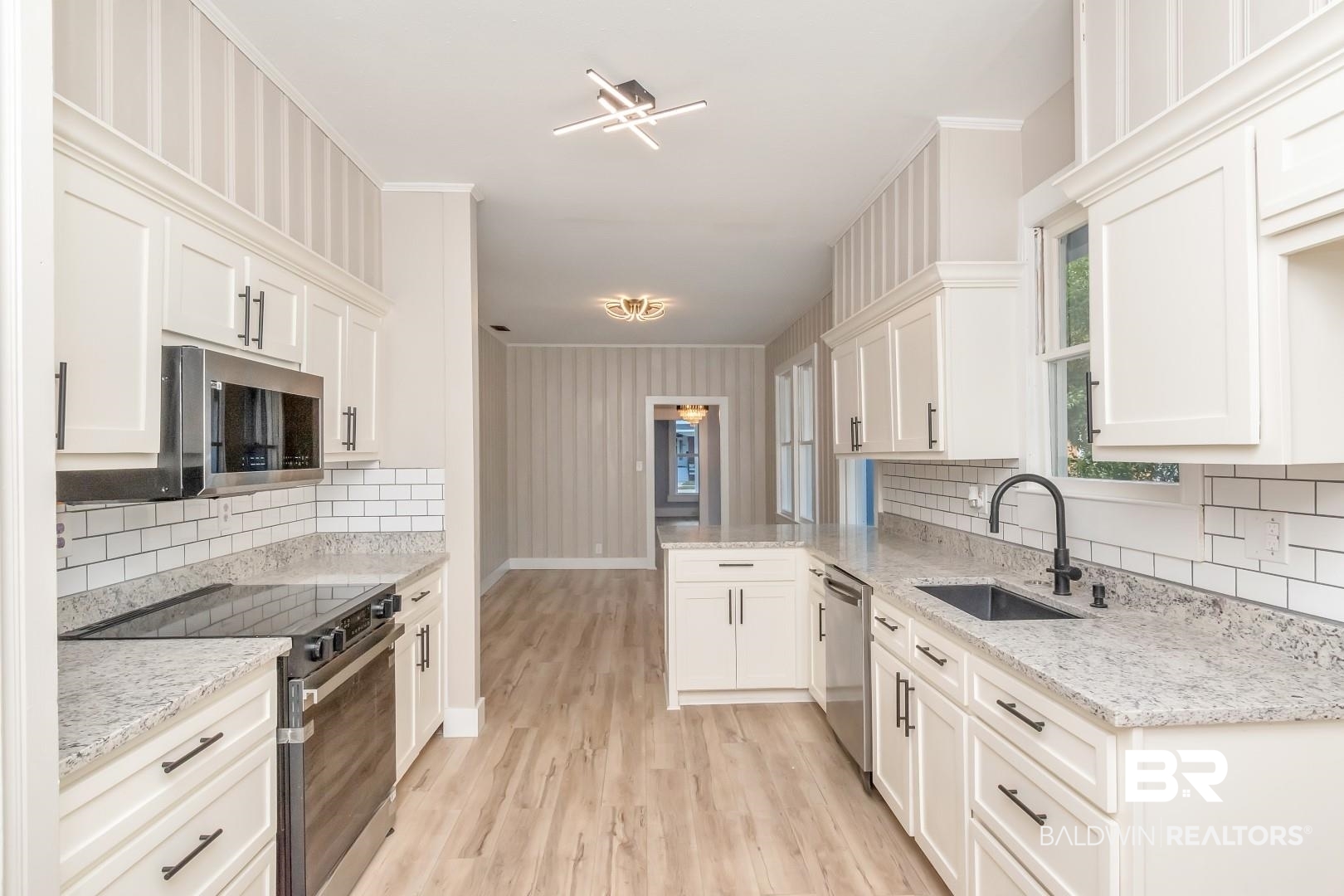 555 Michigan Avenue Mobile, AL 36604 - Photo 14 of 28 Kitchen with white cabinets, appliances with stainless steel finishes, sink, and backsplash